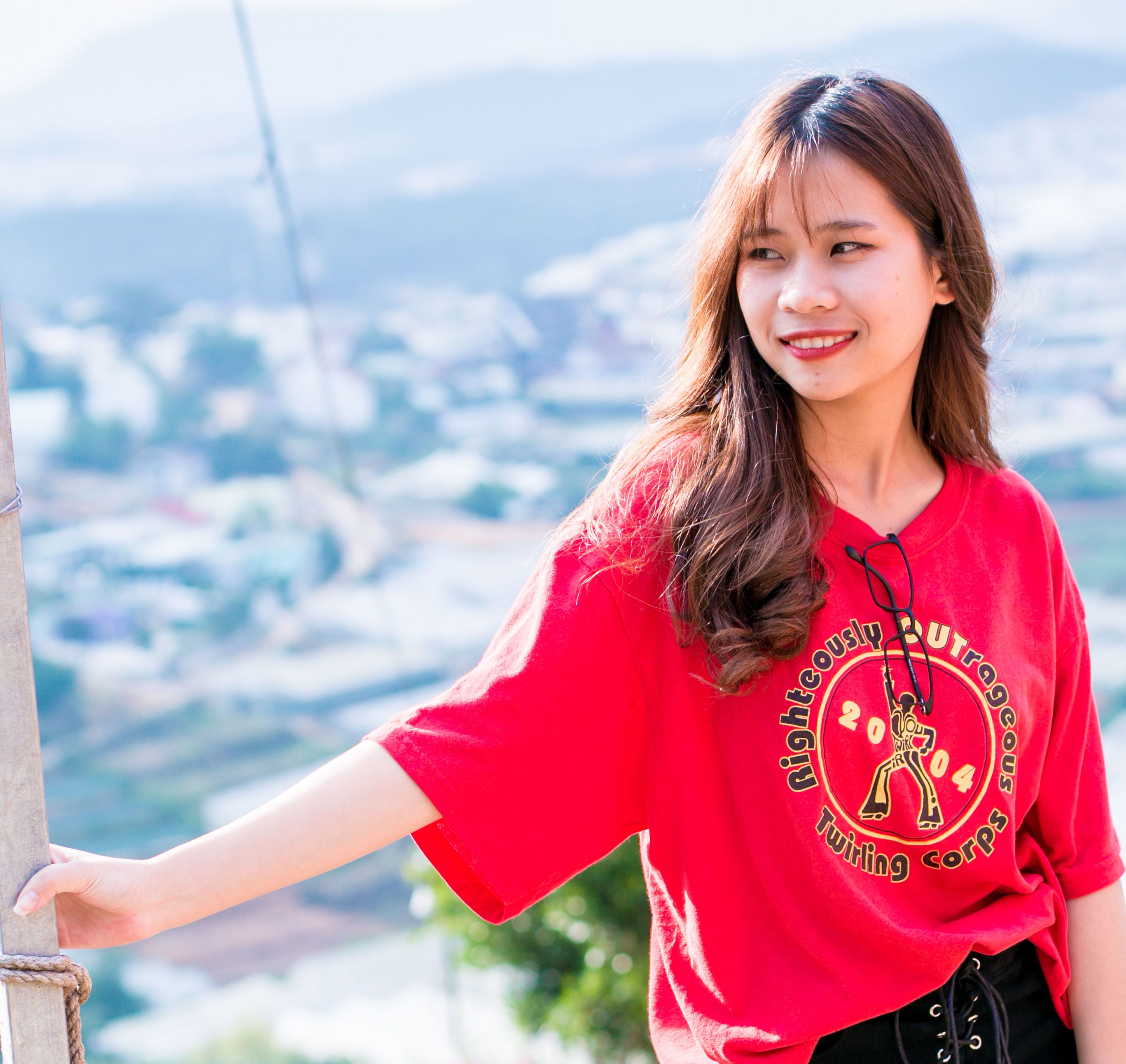 Red tee with gold twirling corps logo